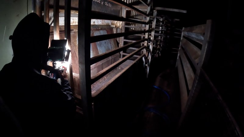 An investigator photographs the knockbox at night