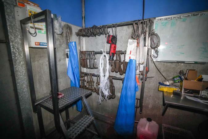 Shackles and aprons hanging in kill room