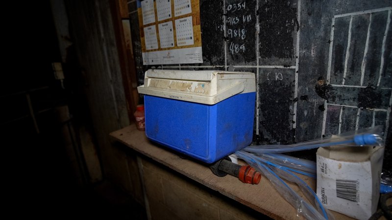 Blackboard, cooler and pork storks near mating stalls