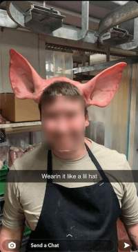 Abattoir worker poses with pig scalp and ears - This photo of a Victorian abattoir worker jokingly posing with the scalp and ears of a recently slaughtered pig on their head was uploaded to an individual's Snapchat story with the caption, 