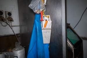 Apron and knives in kill room - An apron and knife set hangs in the kill room. - Captured at Crows Nest Meatworks, Crows Nest QLD Australia.